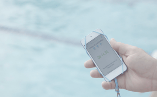 Swimmingly App on Phone in front of Pool